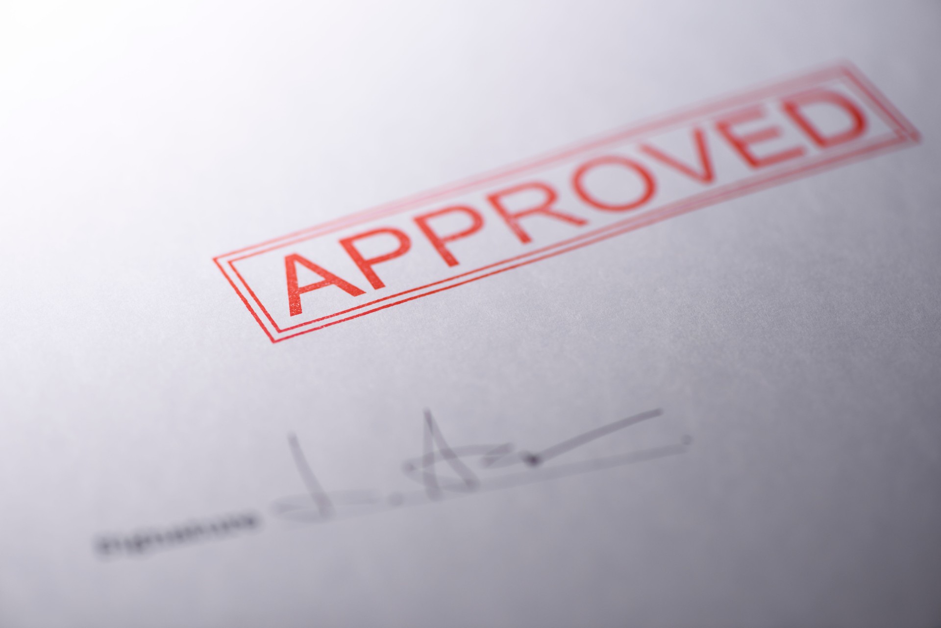 Close-up of blank contract form with approved stamped
