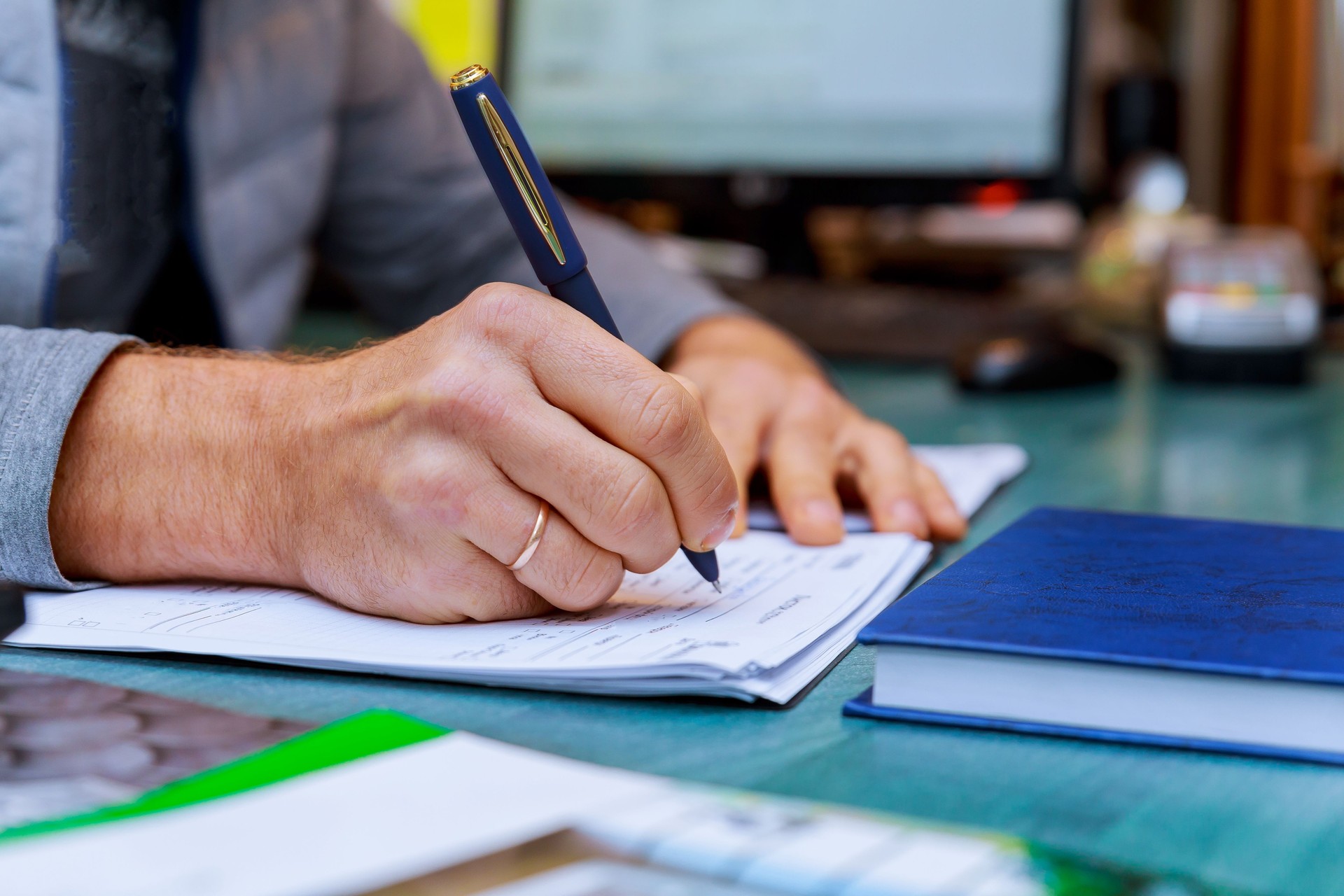Person completing man hand with pen and business of application form